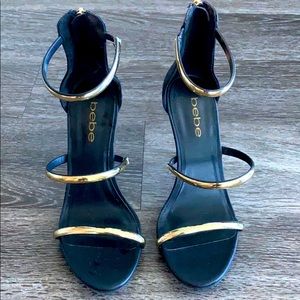 Black heels w/ gold straps, never worn, no box.